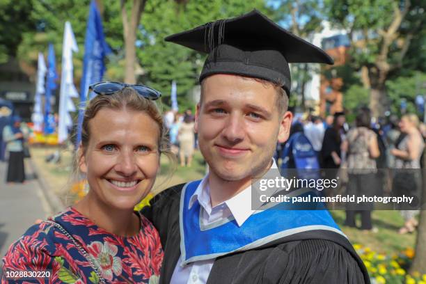 mother and son at graduation ceremony - graduation clothing stock pictures, royalty-free photos & images