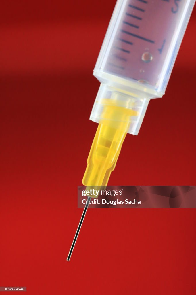 Hyper Needles Disposable Syringe And Hyperdermic Needle On A Red Background High-Res ...