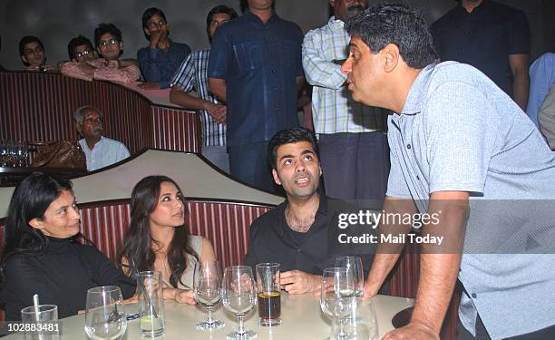 Ronnie Screwvala speaks to wife Zarina as Rani Mukherjee and Karan Johar look on during the music launch of Aamir Khan's forthcoming movie "Peepli...