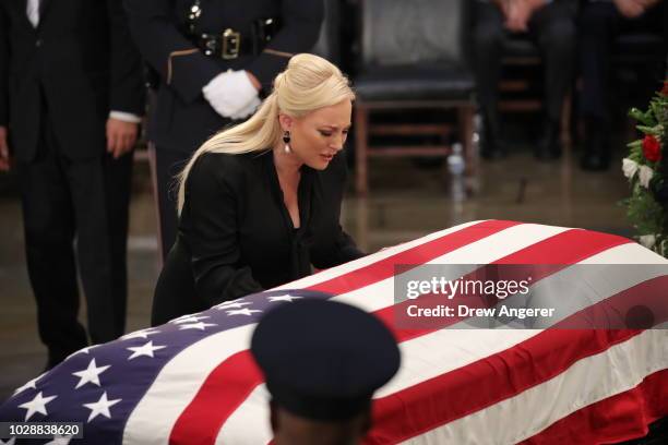 Meghan McCain, daughter of Sen. John McCain, touches the casket during the ceremony honoring the late US Senator inside the Rotunda of the U.S....
