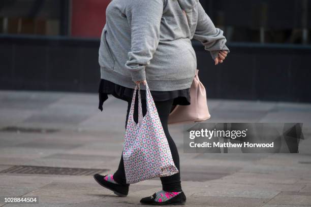 Woman carries a shopping bag through Cardiff city centre on May 23, 2016 in Cardiff, United Kingdom.