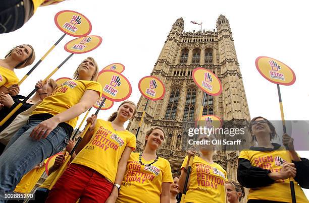 Protesters hold up placards outside the Houses of Parliament campaigning against the sex trafficking of young people on July 14, 2010 in London,...