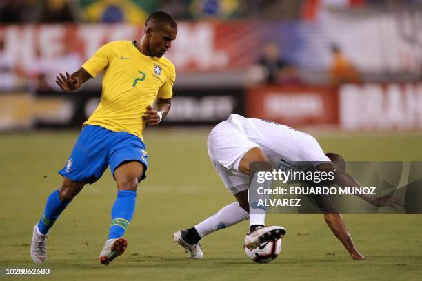 Brazil's midfielder Douglas Costa vies for the ball with US foward Julian Green during their friendly match at the Metlife Stadium in East...