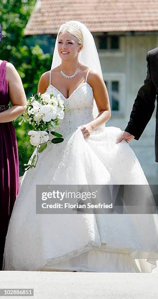 Claudia Schattenberg arrives for her church wedding with FC Bayern Muenchen football player Philipp Lahm at the Sankt Emmerans church on July 14,...