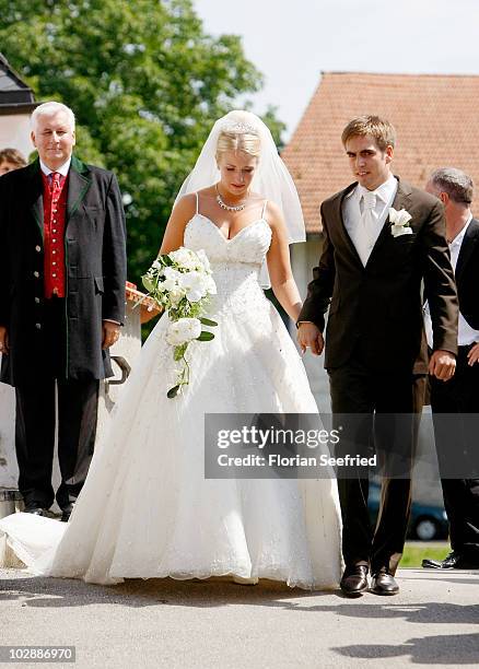 Bayern Muenchen football player Philipp Lahm and his wife Claudia Schattenberg leave their church wedding at the Sankt Emmerans church on July 14,...