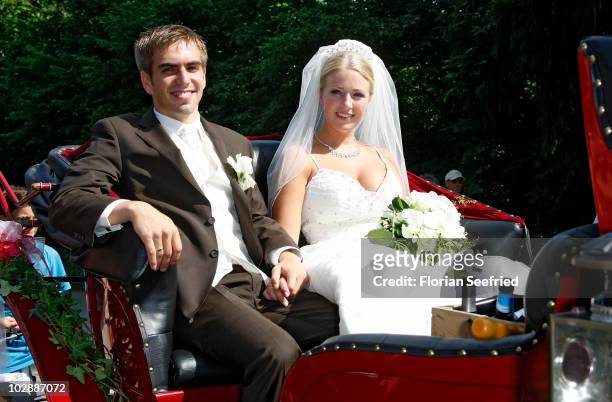 Bayern Muenchen football player Philipp Lahm and his wife Claudia Schattenberg leave their church wedding at the Sankt Emmerans church on July 14,...