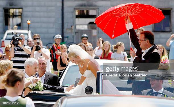 Claudia Schattenberg arrives for her church wedding with FC Bayern Muenchen football player Philipp Lahm at the Sankt Emmerans church on July 14,...