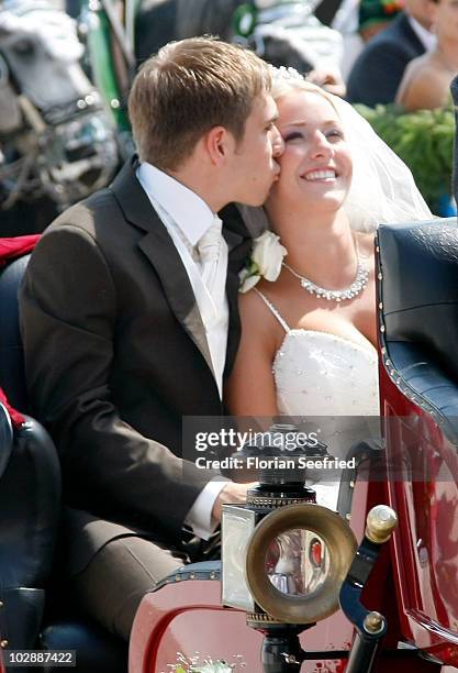 Bayern Muenchen football player Philipp Lahm and his wife Claudia Schattenberg leave their church wedding at the Sankt Emmerans church on July 14,...