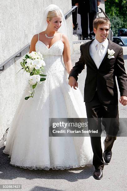 Bayern Muenchen football player Philipp Lahm and his wife Claudia Schattenberg leave their church wedding at the Sankt Emmerans church on July 14,...