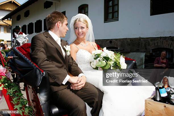 Bayern Muenchen football player Philipp Lahm and his wife Claudia Schattenberg leave their church wedding at the Sankt Emmerans church on July 14,...