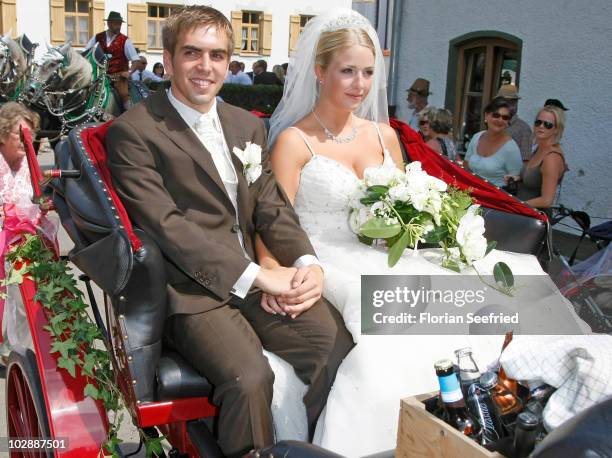 Bayern Muenchen football player Philipp Lahm and his wife Claudia Schattenberg leave their church wedding at the Sankt Emmerans church on July 14,...