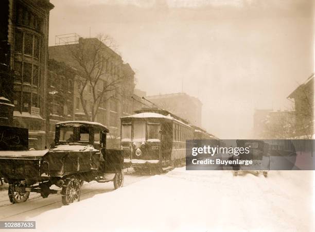 View of trolleys and vehicles stuck and lined up on the city streets during the Knickerbocker blizzard, Washington, DC, 1922.