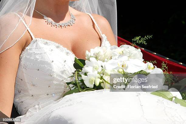Decolletage, jewellery and bridal bouquet of Claudia Schattenberg is pictured after her church wedding with Philipp Lahm at the Sankt Emmerans Chruch...