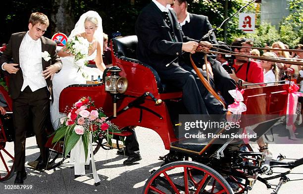 Bayern Muenchen football player Philipp Lahm and his wife Claudia Schattenberg arrive for the wedding party at Brauereigasthof on July 14, 2010 in...