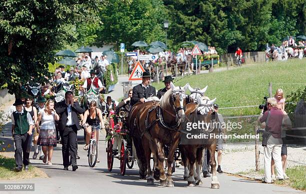 Guests of FC Bayern Muenchen football player Philipp Lahm and wife Claudia, arrive for the wedding party at Brauereigasthof on July 14, 2010 in...