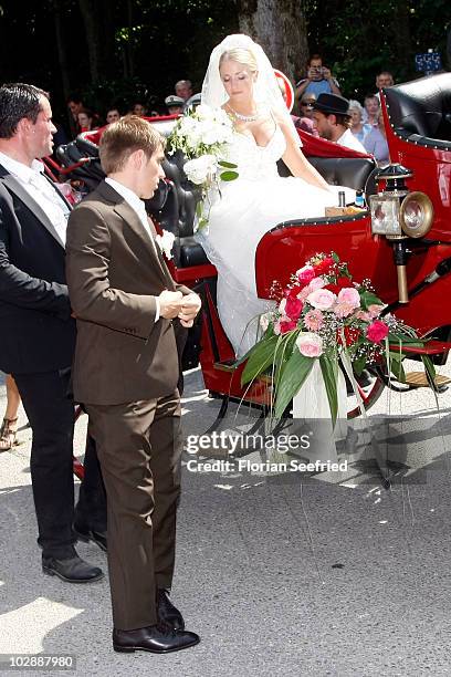 Bayern Muenchen football player Philipp Lahm and his wife Claudia Schattenberg arrive for the wedding party at Brauereigasthof on July 14, 2010 in...