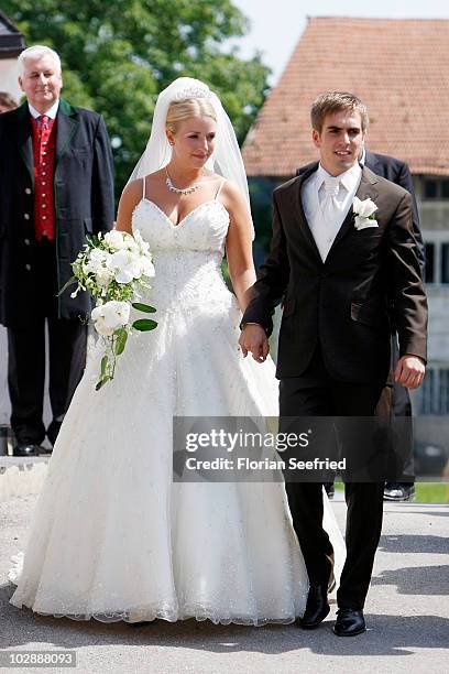 Bayern Muenchen football player Philipp Lahm and his wife Claudia Schattenberg leave their church wedding at the Sankt Emmerans church on July 14,...