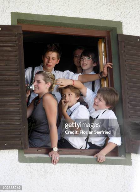 Children watch the church wedding of FC Bayern Muenchen football player Philipp Lahm and his wife Claudia Schattenberg at the Sankt Emmerans church...