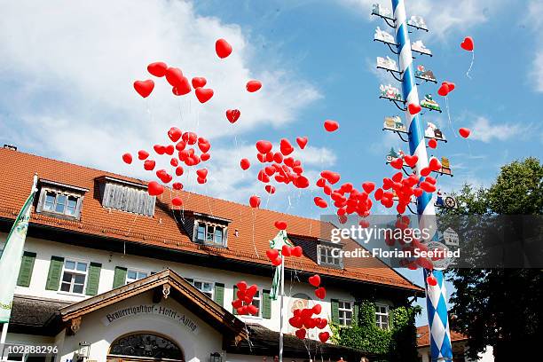 Balloons fly in front of the Brauereigasthof during the wedding party of FC Bayern Muenchen football player Philipp Lahm and his wife Claudia...