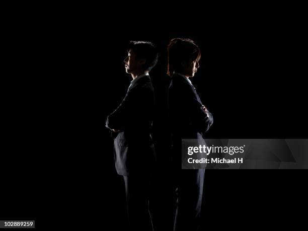 two businessmen who turned its back - men confrontation stock pictures, royalty-free photos & images