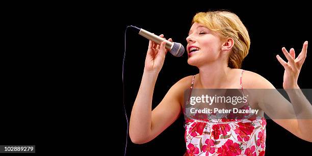 teenager singing karaoke - blonde female singers stock-fotos und bilder