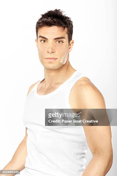 portrait of healthy young man in the studio - man in tank top stock pictures, royalty-free photos & images