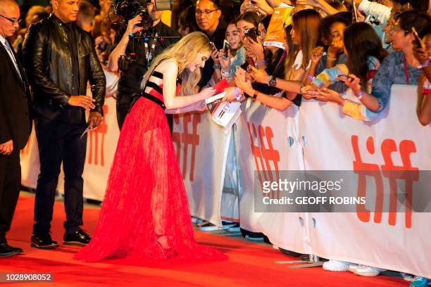 Singer Sabrina Carpenter sings autographs as she attends the premiere of "The Hate You Give" at the Toronto International Film Festival in Toronto,...