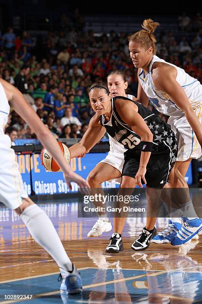 Becky Hammon of the San Antonio Silver Stars looks to pass while defended by Erin Torn and Christi Thomas of the Chicago Sky during the WNBA game on...