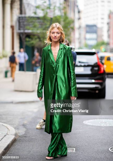 Martha Hunt wearing green button dress and pants seen outside Jason Wu during New York Fashion Week Spring/Summer 2019 on September 7, 2018 in New...