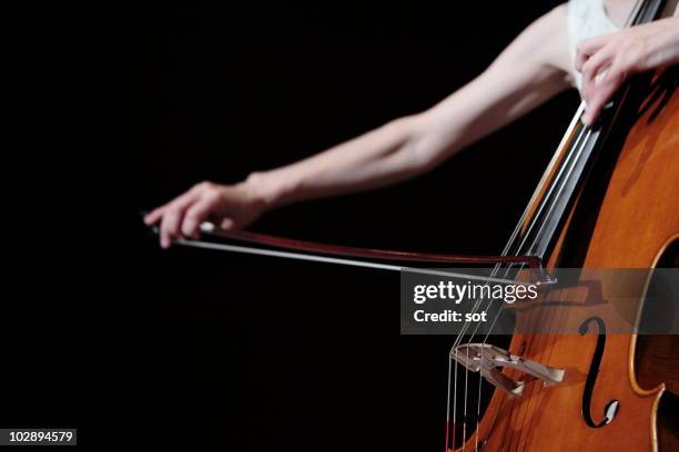 a female cellist playing cello on stage,close up - cellist stock pictures, royalty-free photos & images