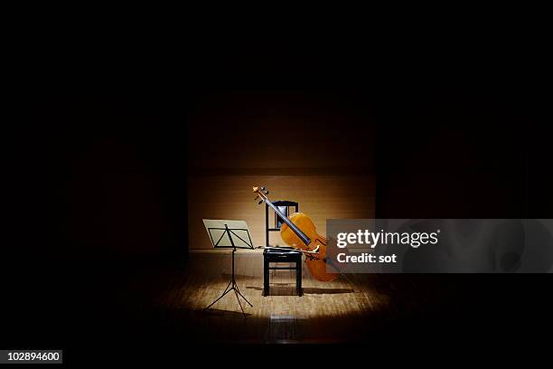 cello with chair and music stand on stage. - music stand stock pictures, royalty-free photos & images