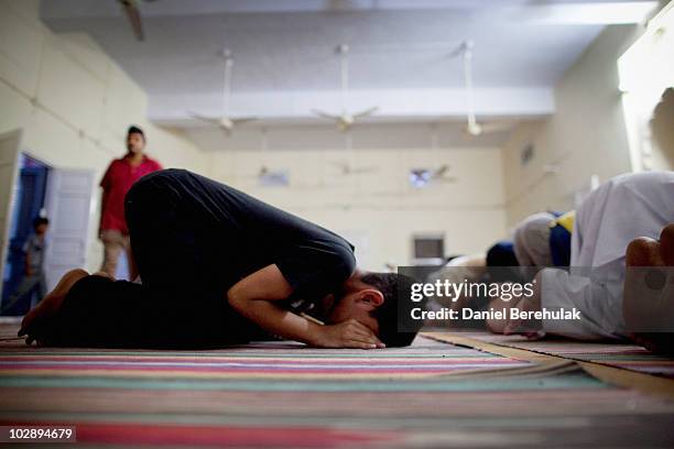 Members of the persecuted Ahmadiyya community pray in a mosque on July 14, 2010 in Chenab Nagar, Pakistan. The Pakistani Ahmadis, define themselves...