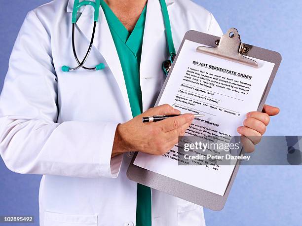 senior doctor with do not resuscitate order form - ethical treatment foto e immagini stock