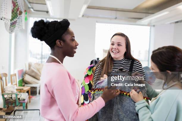 teenage girls designing denim jacket in fashion design class - versierd jak stockfoto's en -beelden