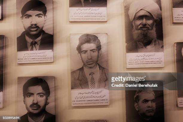 Photographs of martyrs from the persecuted Ahmadiyya community hang on a wall in the Ahmadiyya museum July 14, 2010 in Chenab Nagar, Pakistan. The...