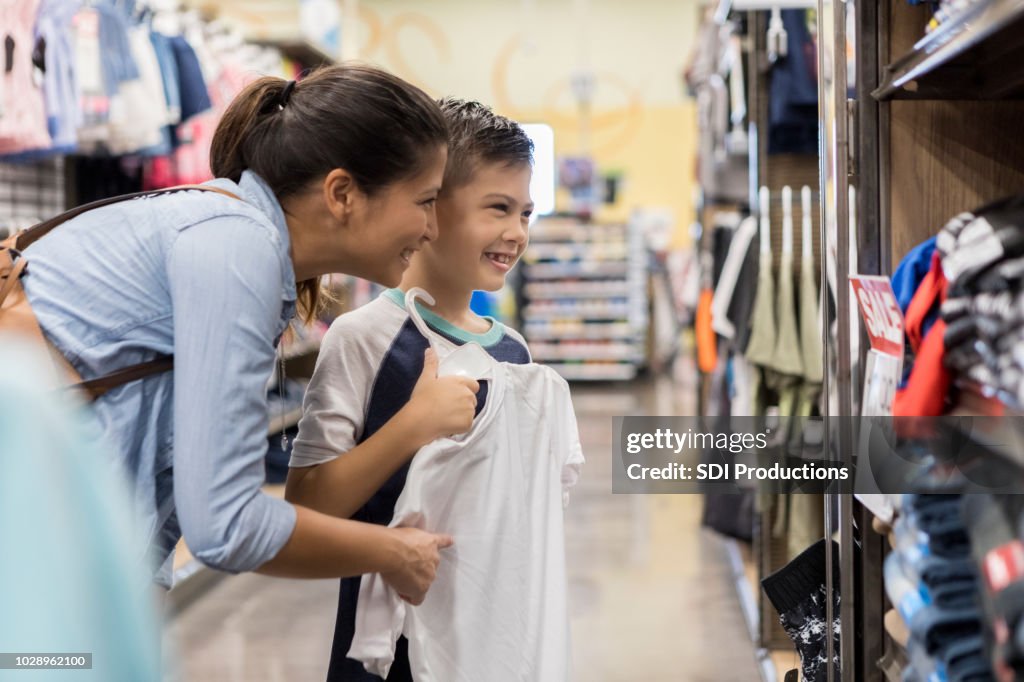 Little boy shops with his mid adult mom