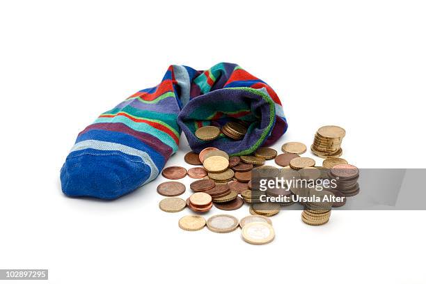 savings sock with euro coins - change socks stockfoto's en -beelden