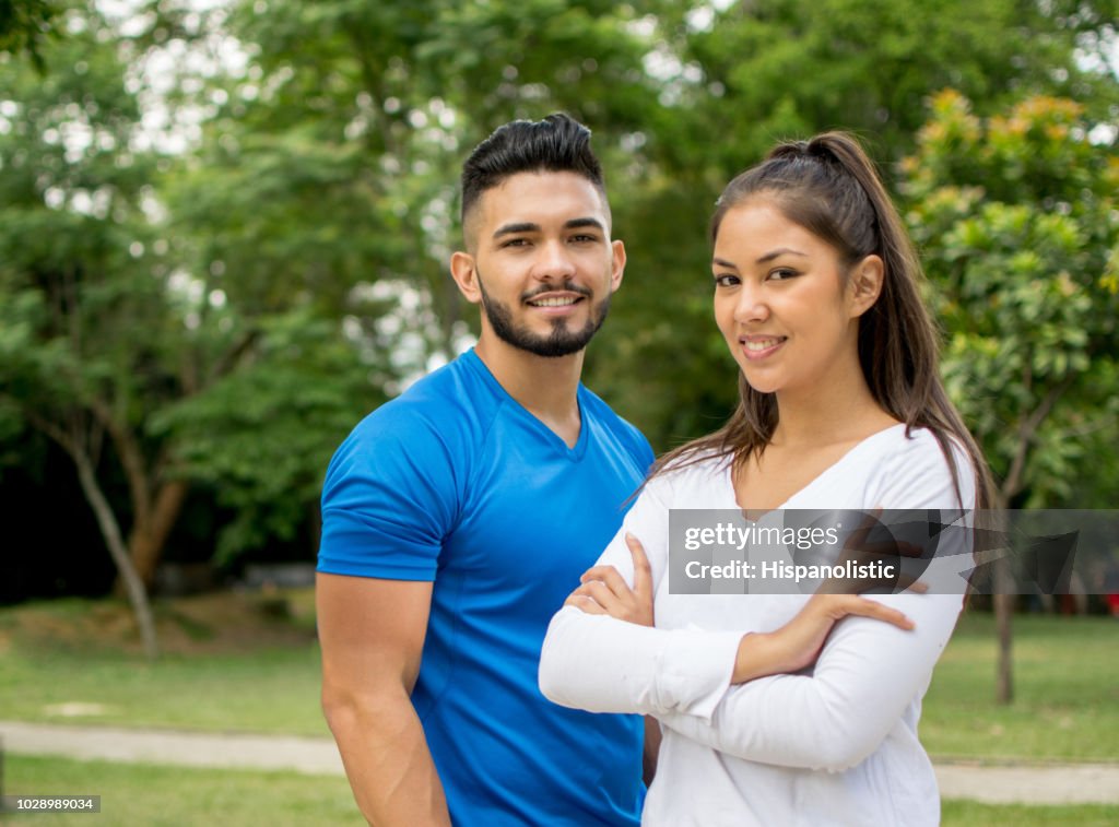 Portrait of happy coach and young fit woman
