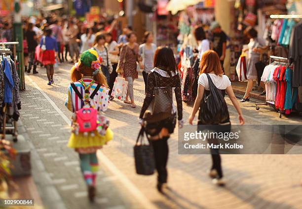 Group of friends walk along Takeshita Street in Harajuku on May 25, 2010 in Tokyo, Japan. Takeshita Street is pedestrian-only shopping strip popular...