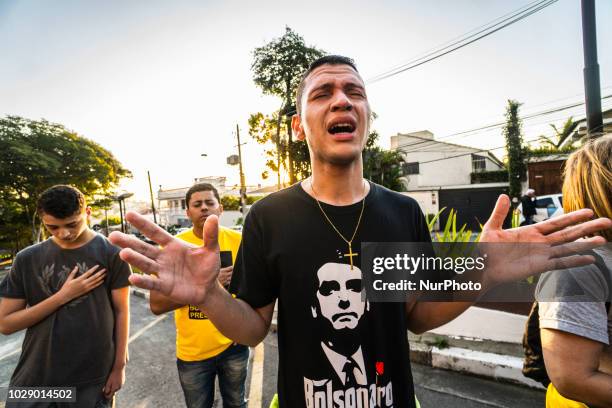 Supporters of Brazilian right-wing presidential candidate Jair Bolsonaro, keep vigil in the front of the Albert Einstein Hospital in Sao Paulo, where...