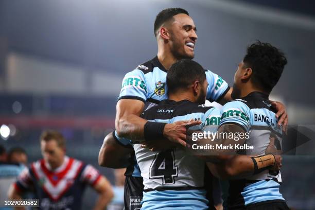 Valentine Holmes and Ricky Leutele of the Sharks celebrate with Sosaia Feki of the Sharks after he scored a try during the NRL Qualifying Final match...