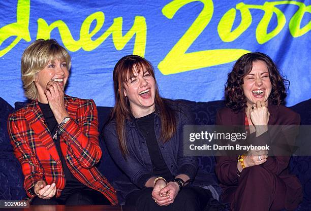 Australia performers Olivia Newton-John, Vanessa Amorosi and Tina Arena share a joke at a press conference to announce the performers at the opening...