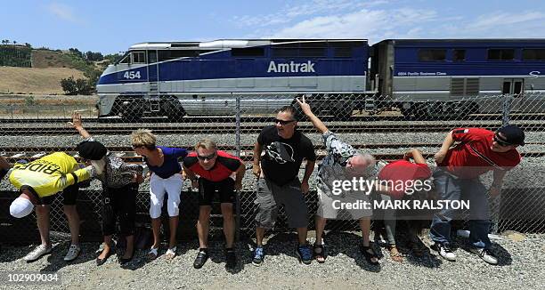 Residents of Laguna Niguel expose their buttocks to a passing Amtrak train during the 31st annual "Mooning of the trains" event along a stretch of...