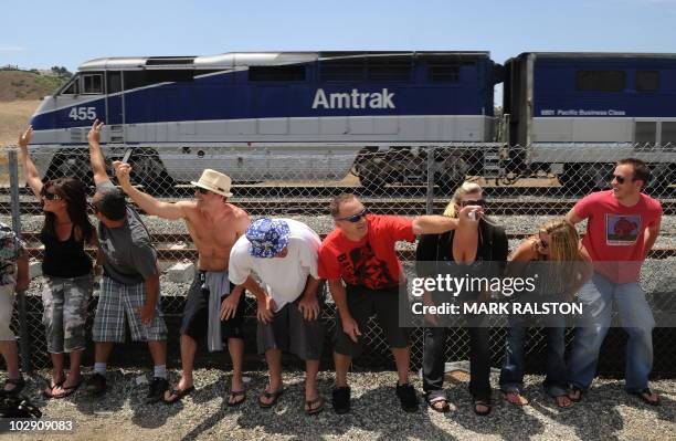 Residents of Laguna Niguel expose their buttocks to a passing Amtrak train during the 31st annual "Mooning of the trains" event along a stretch of...