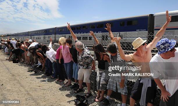 Residents of Laguna Niguel expose their buttocks to a passing Amtrak train during the 31st annual "Mooning of the trains" event along a stretch of...