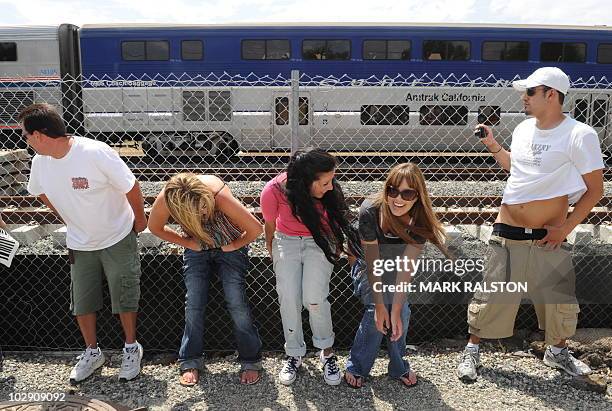 Residents of Laguna Niguel expose their buttocks to a passing Amtrak train during the 31st annual "Mooning of the trains" event along a stretch of...