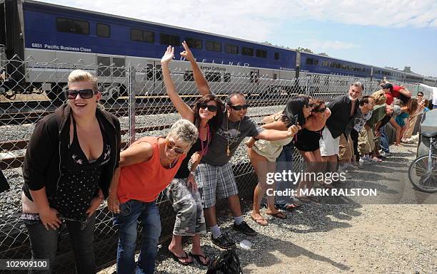 Residents of Laguna Niguel expose their buttocks to a passing Amtrak train during the 31st annual "Mooning of the trains" event along a stretch of...