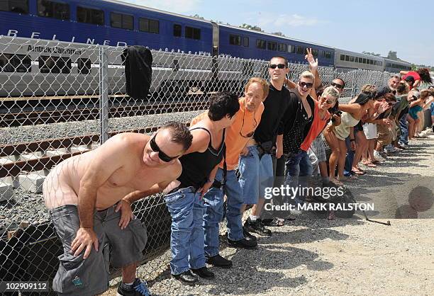 Residents of Laguna Niguel expose their buttocks to a passing Amtrak train during the 31st annual "Mooning of the trains" event along a stretch of...