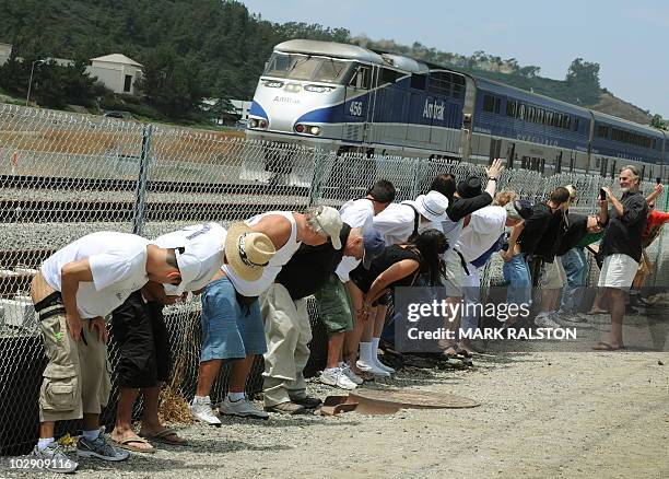 Residents of Laguna Niguel expose their buttocks to a passing Amtrak train during the 31st annual "Mooning of the trains" event along a stretch of...