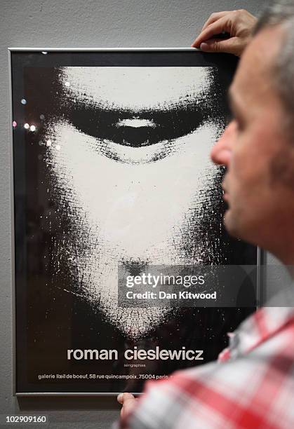 Curator David Crowley puts the finishing touches to an exhibition by Polish artist and graphic designer Roman Cieslewicz at the Royal Academy of Arts...